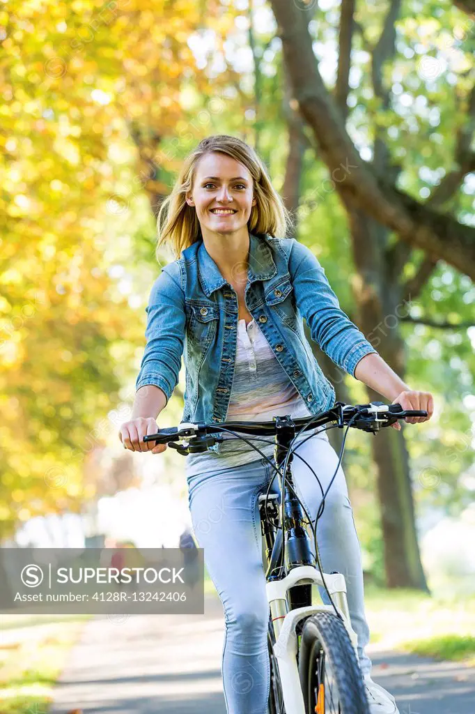 Young woman riding a bicycle.