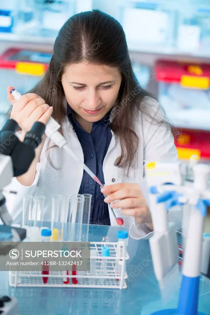 Female laboratory technician using a pipette in the laboratory.
