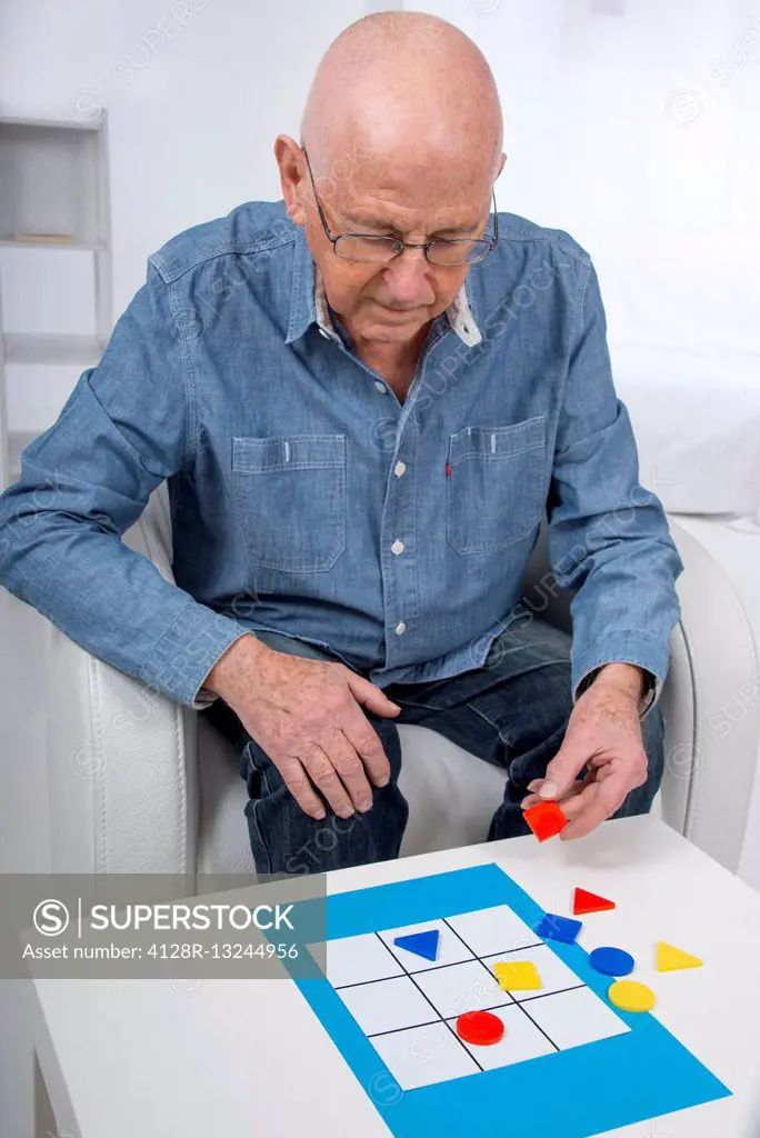 MODEL RELEASED. Senior man playing game.