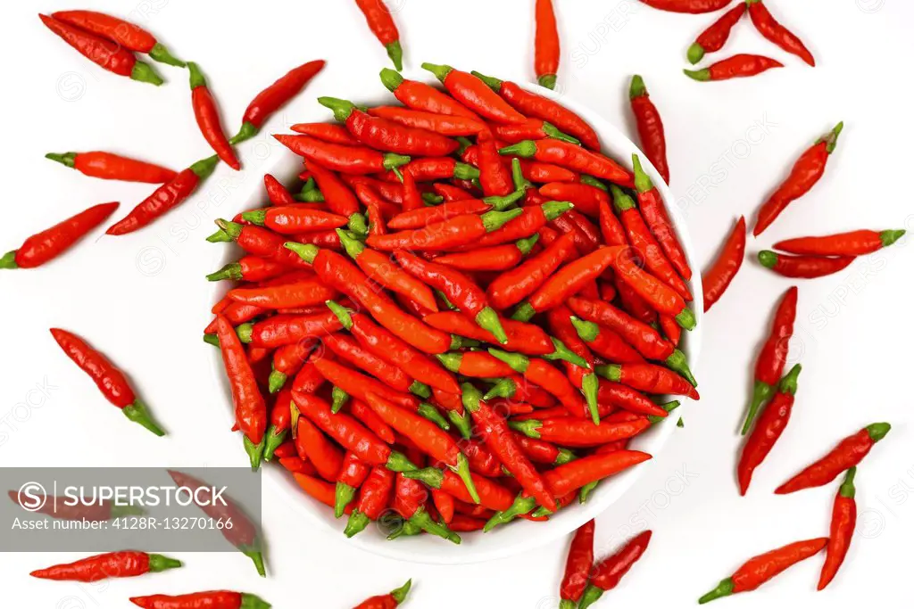 Red chilli peppers against a white background.
