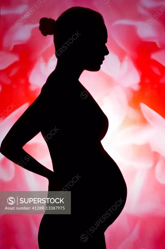 MODEL RELEASED. Silhouette of a pregnant woman.