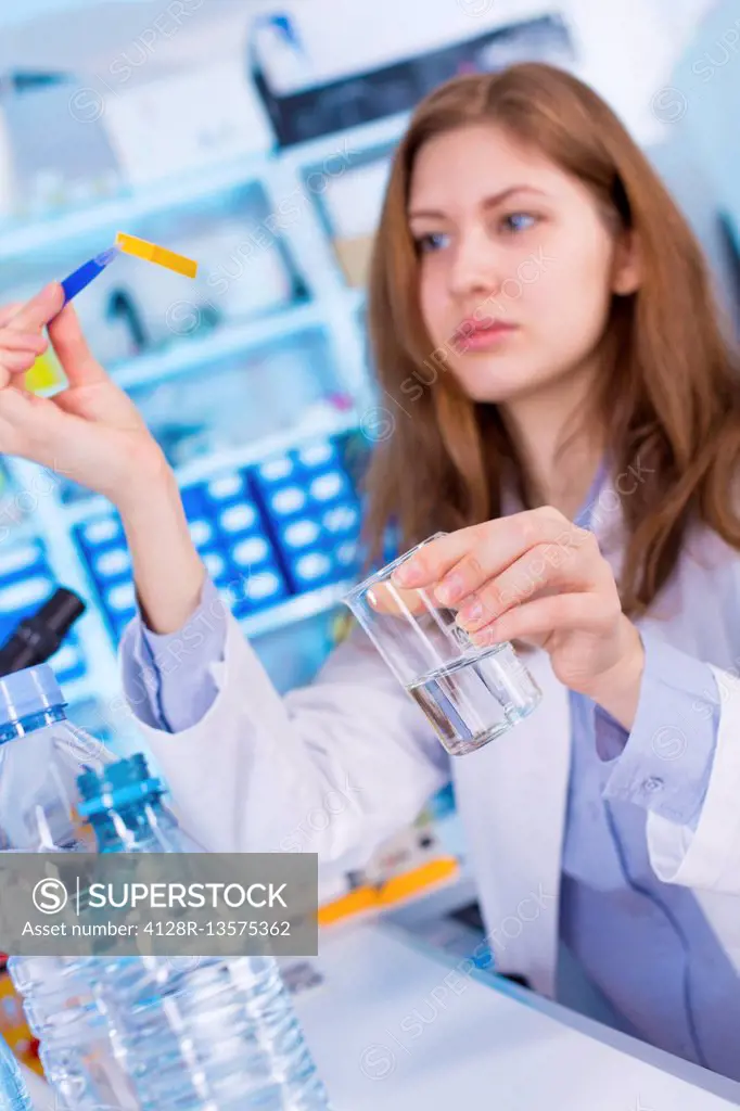 MODEL RELEASED. Woman testing water in laboratory.