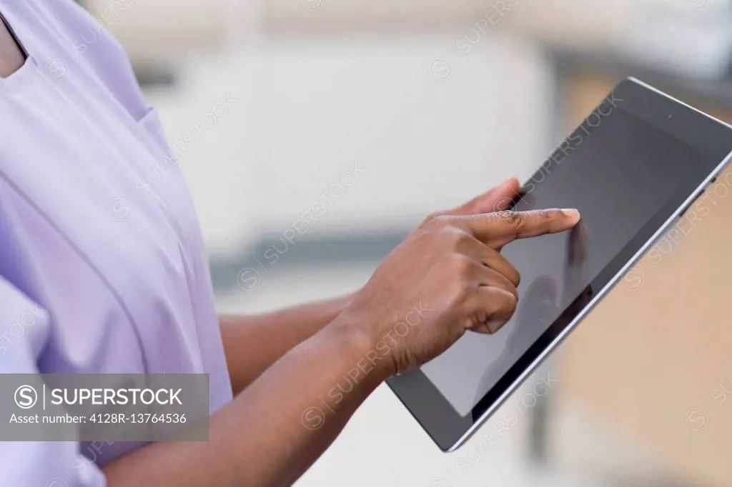 Female nurse using digital tablet.
