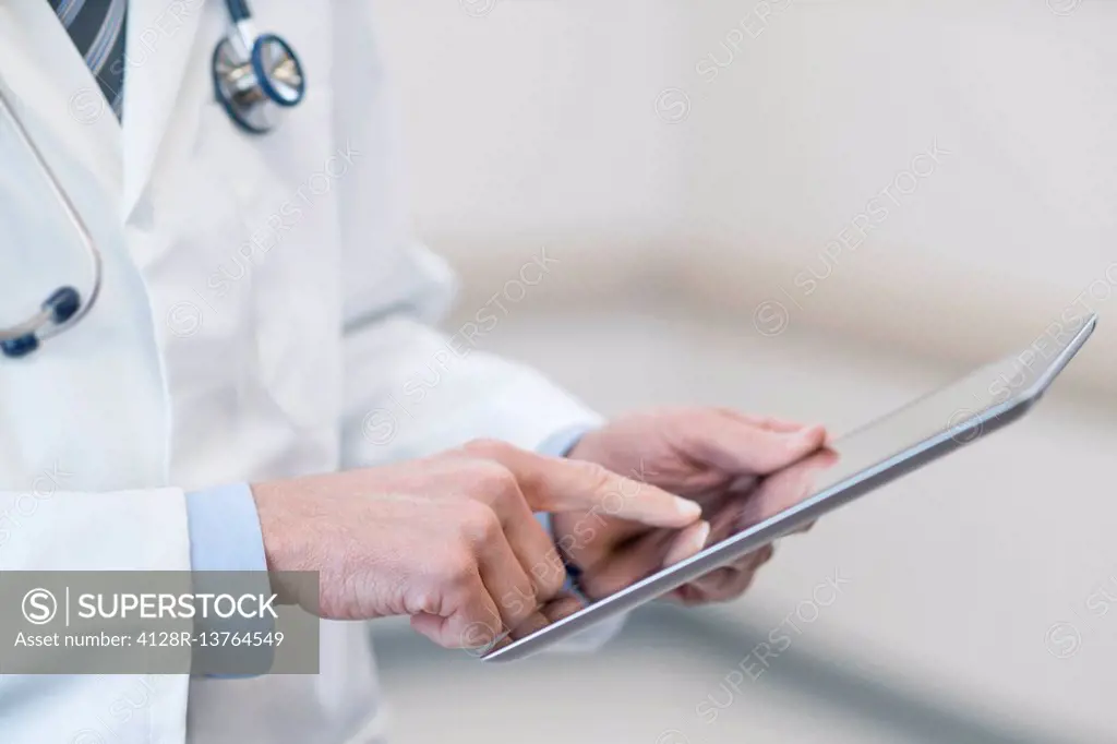 Male doctor using digital tablet.