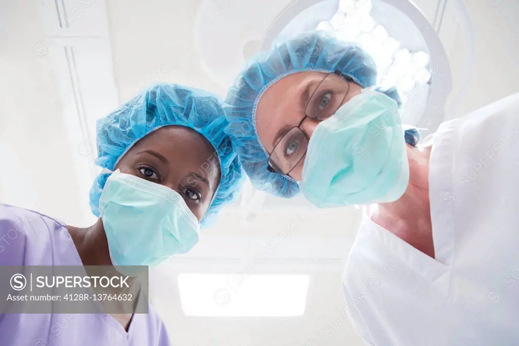 Two female surgeons looking towards camera, personal perspective.