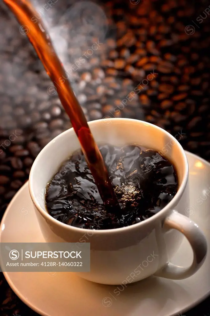 Fresh coffee being poured into cup