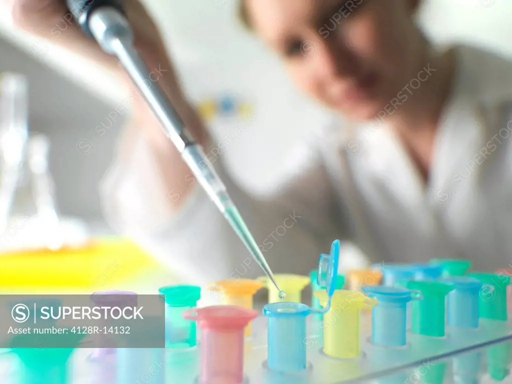 Biological research. Scientist pipetting a liquid into Eppendorf tubes.