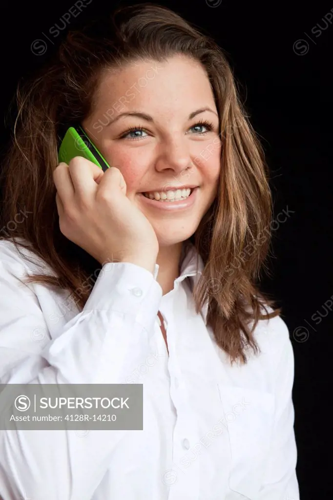 Mobile phone use. Teenage girl talking on a mobile phone.