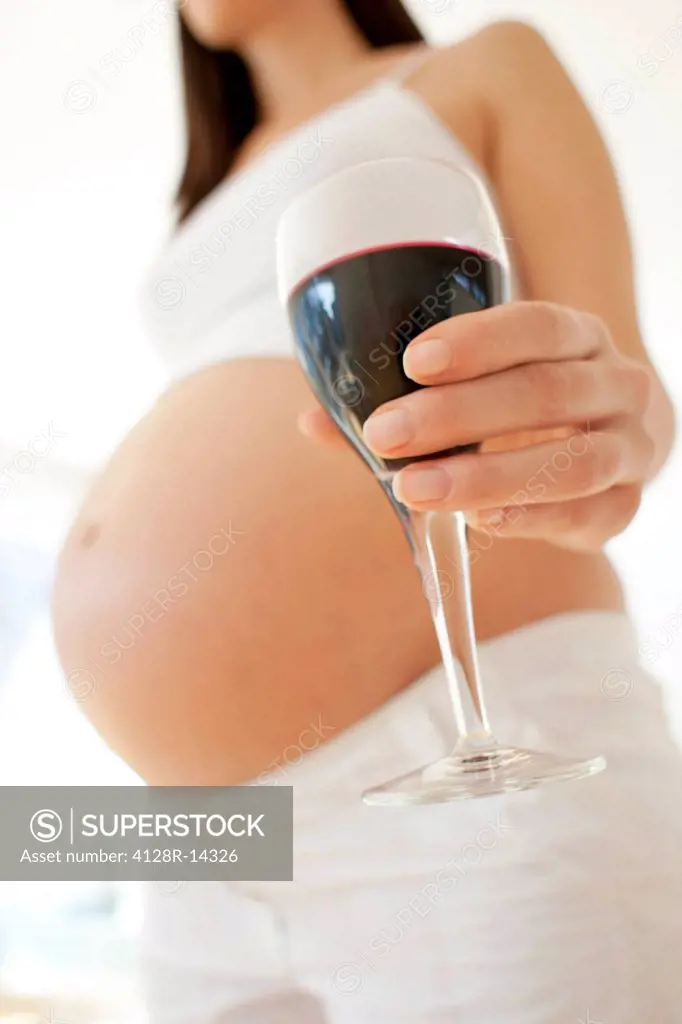 Pregnant woman with a glass of wine.