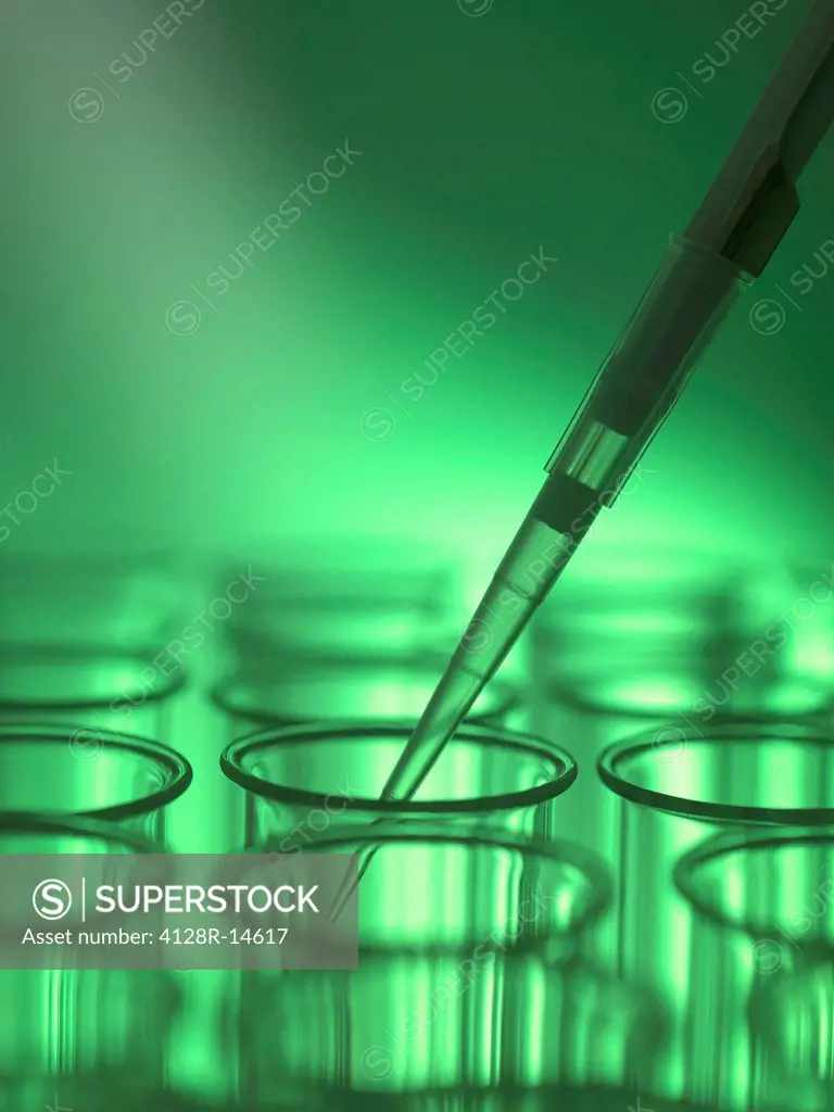 Pipetting liquid into a test tube.