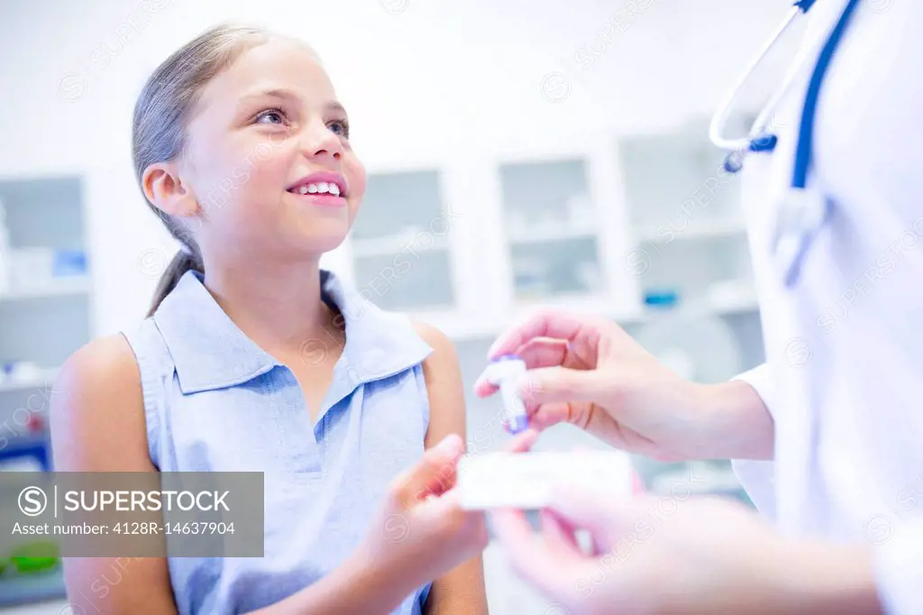 Doctor giving girl a finger prick test