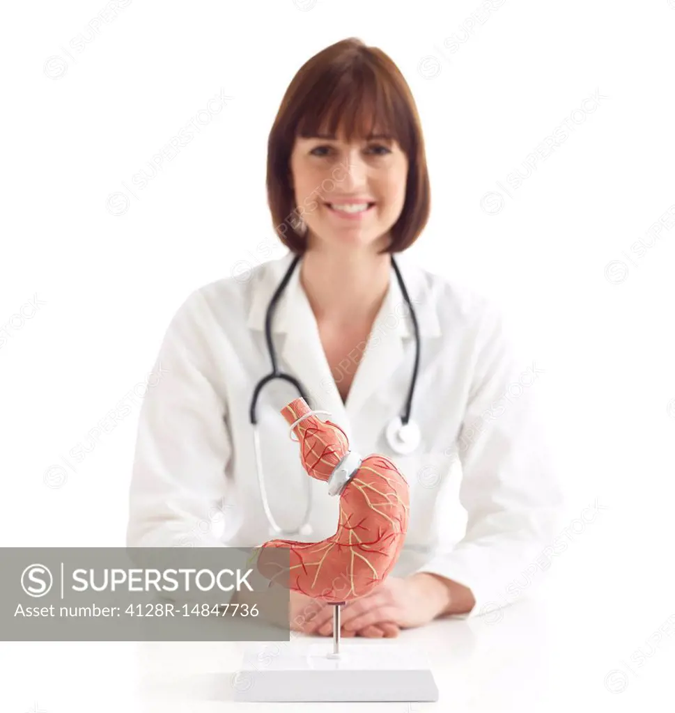 Doctor with model of stomach with gastric band