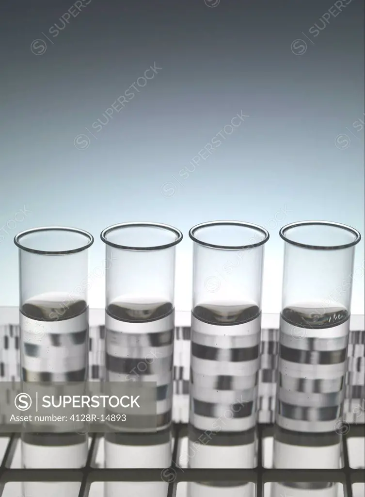 Genetic research. Test tubes sitting in front of a DNA deoxyribonucleic acid autoradiogram.