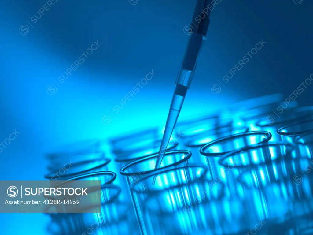 Pipetting liquid into a test tube.
