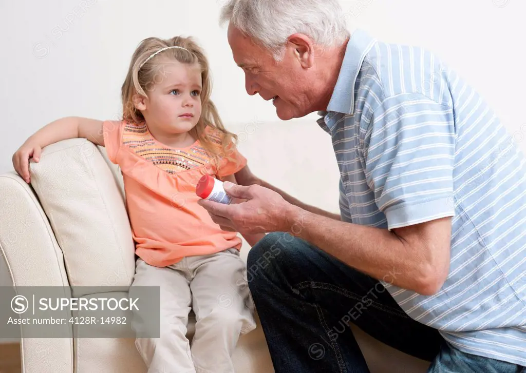 First aid for poisoning. Man asking a young girl if she has swallowed some pills.