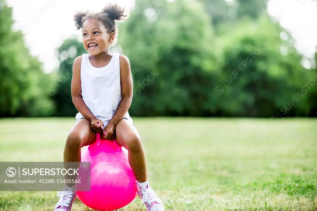 Girl bouncing on inflatable hopper
