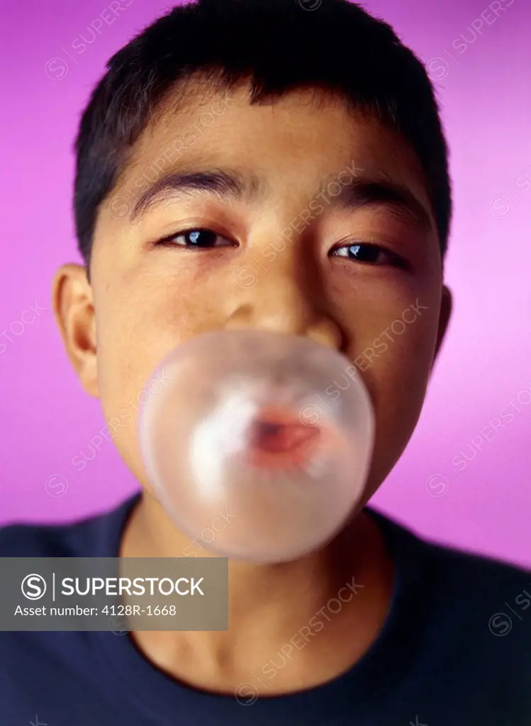 Boy blowing bubblegum bubble