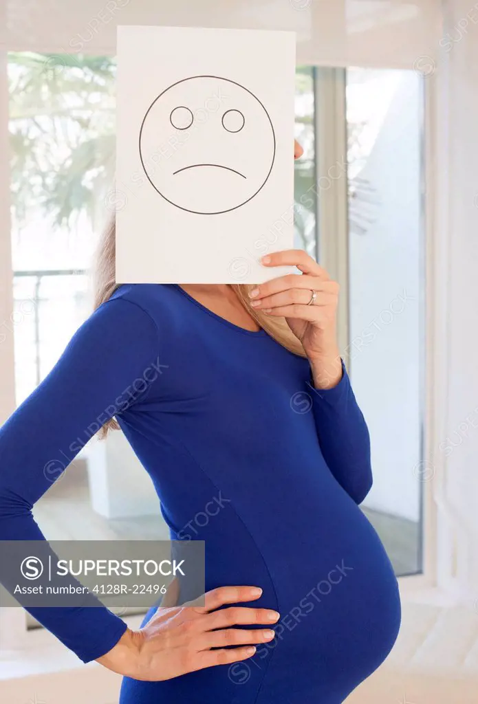 MODEL RELEASED. Unhappy pregnant woman. She is 8 months pregnant.