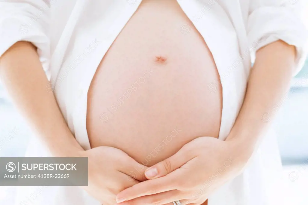 MODEL RELEASED. Pregnant woman´s abdomen. She is seven months pregnant.