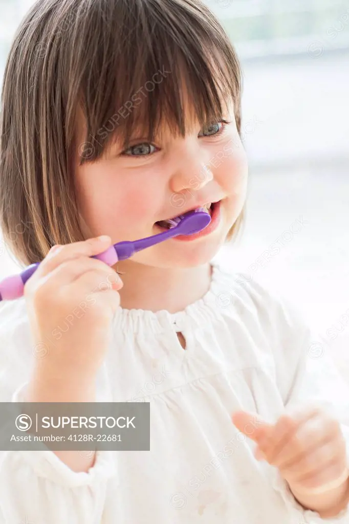 MODEL RELEASED. Toddler brushing her teeth.