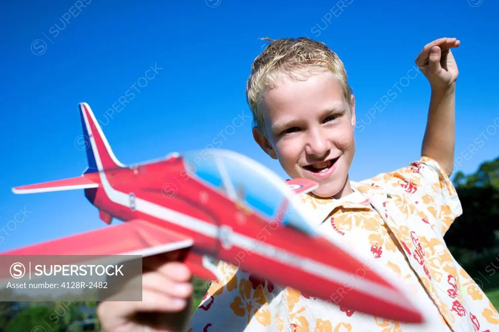 Boy playing with a model aeroplane
