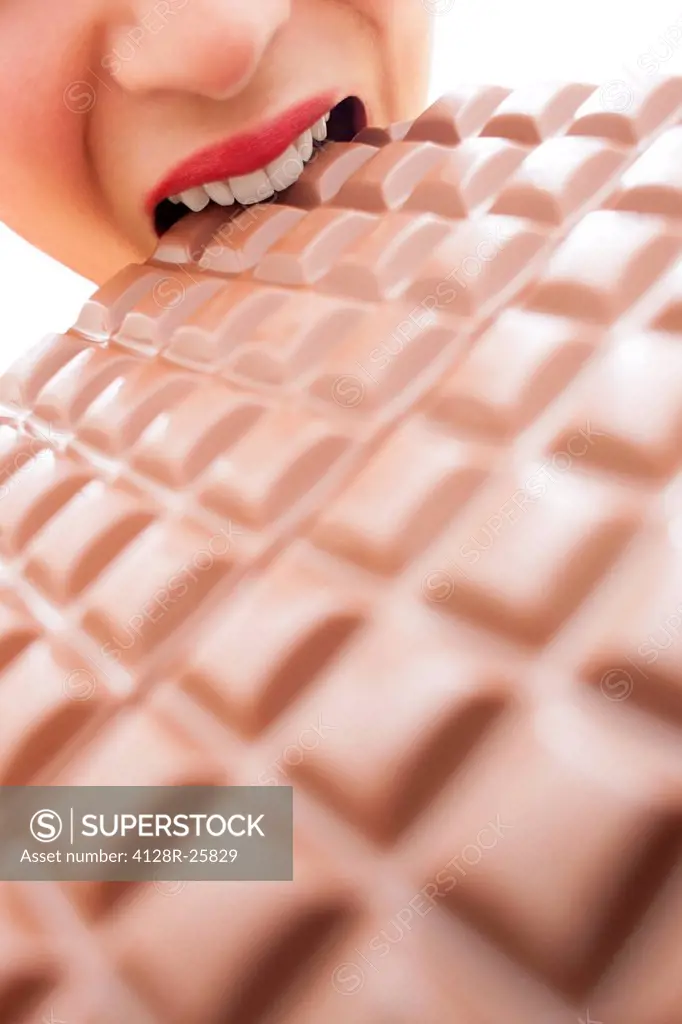 MODEL RELEASED. Woman eating chocolate.