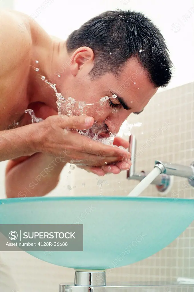 MODEL RELEASED. Man washing his face.