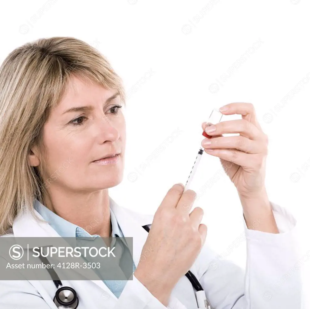 Doctor preparing a syringe.