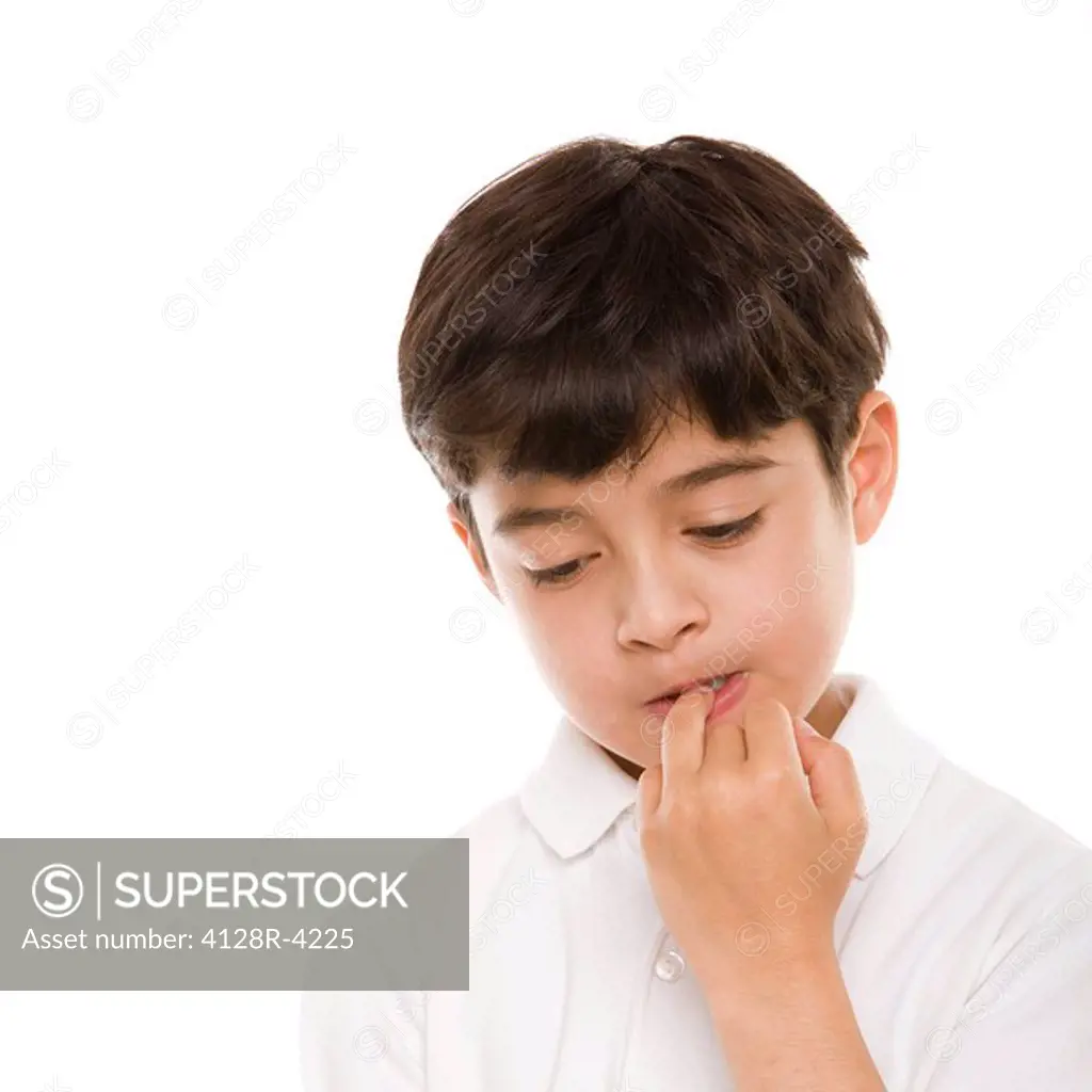 Boy biting his nails.
