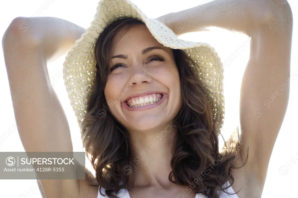 Happy woman wearing a sunhat