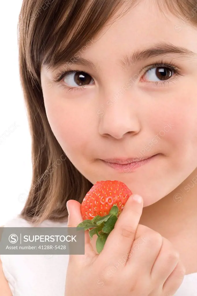 Girl eating a strawberry.