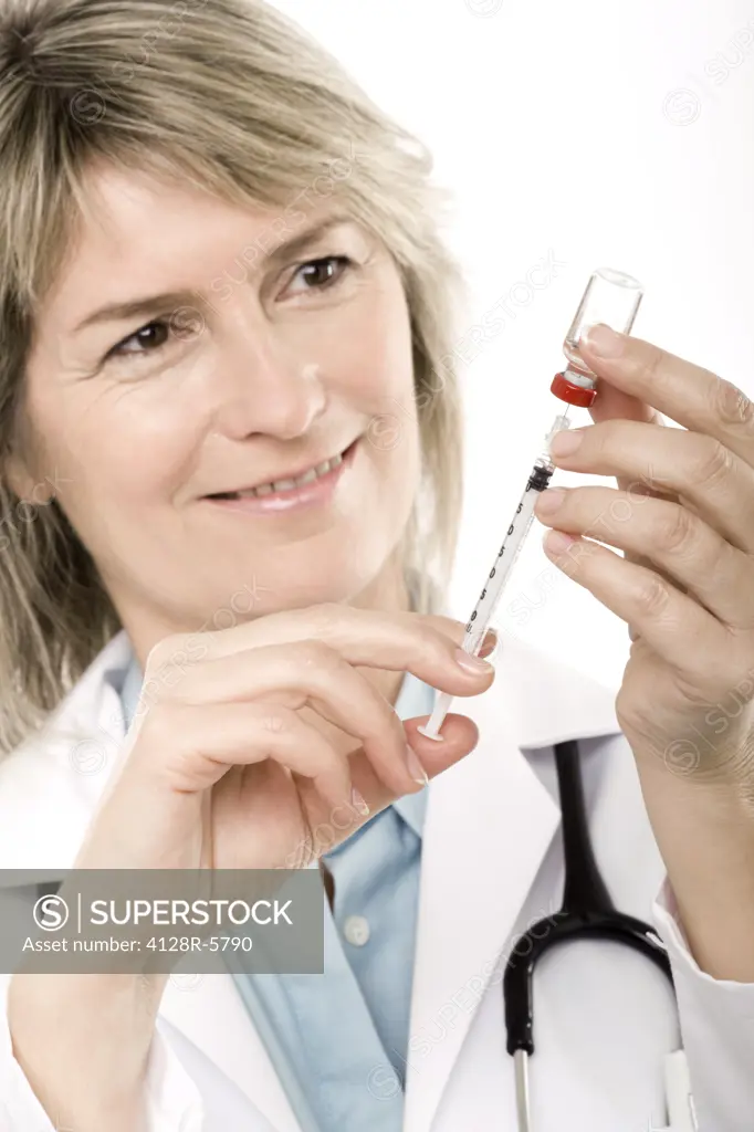 Doctor preparing a syringe.