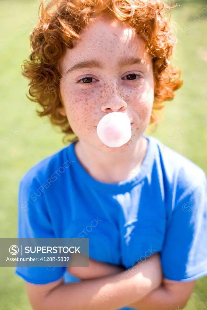 Boy blowing bubblegum