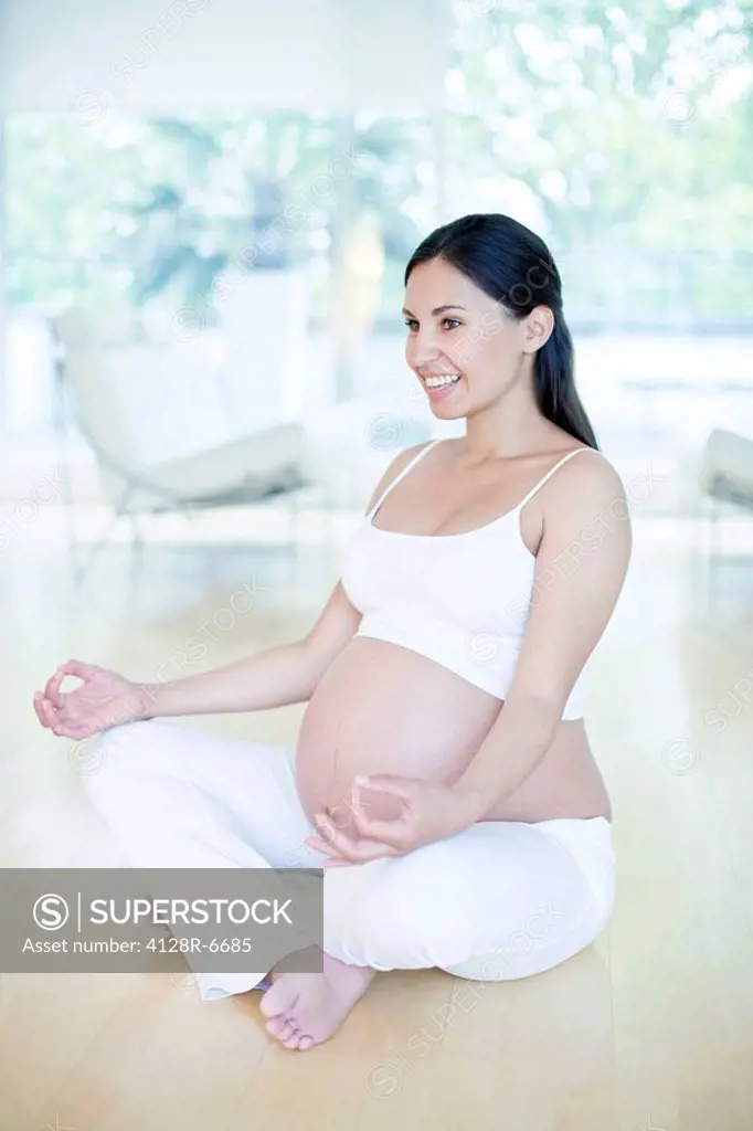 Yoga in pregnancy. The woman is eight months pregnant.