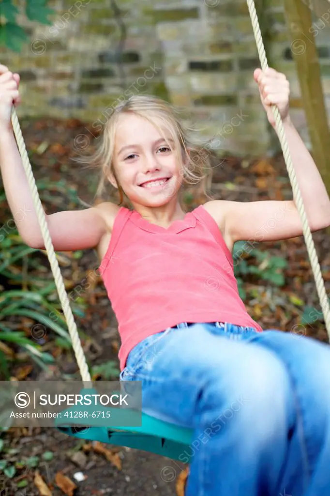 Girl playing on a swing