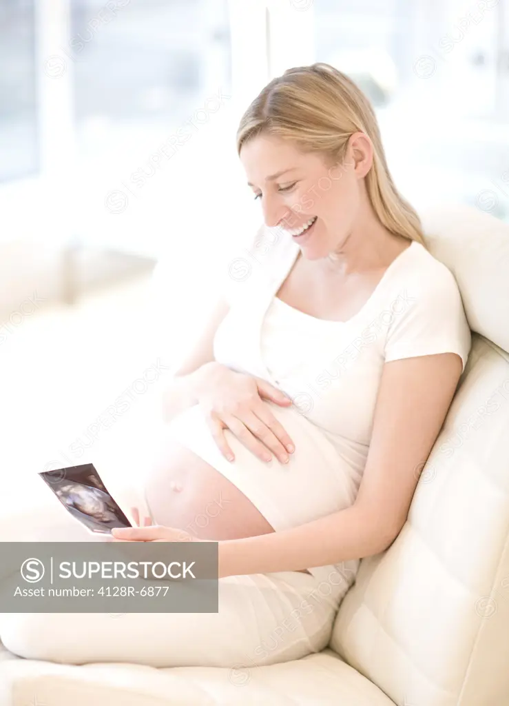 Pregnant woman looking at her baby scan