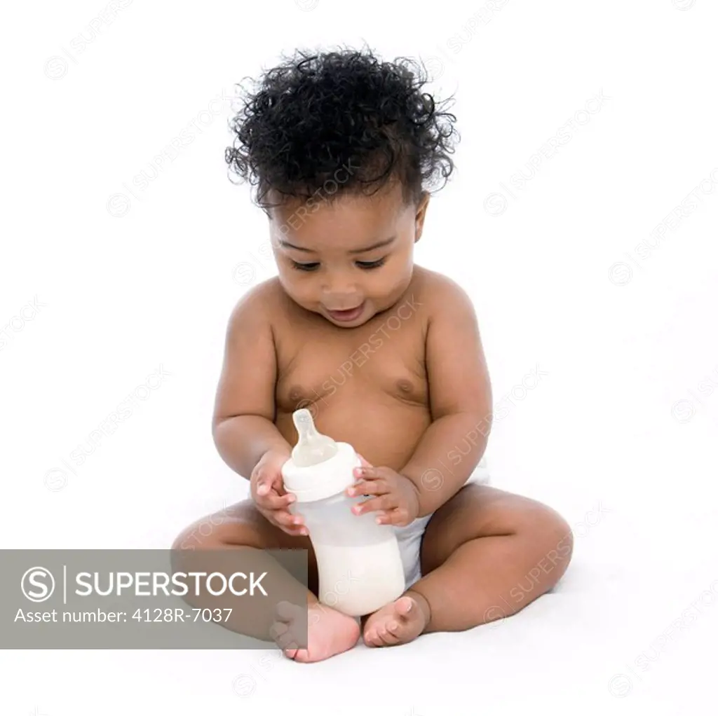 Baby girl with a bottle of milk.