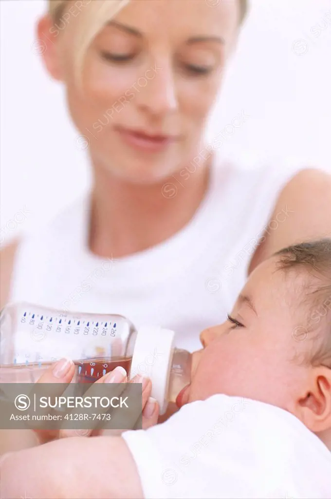 Mother bottle_feeding baby boy