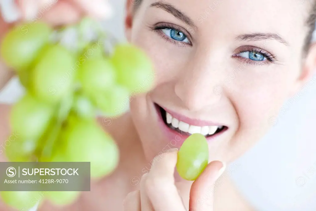 Woman eating grapes