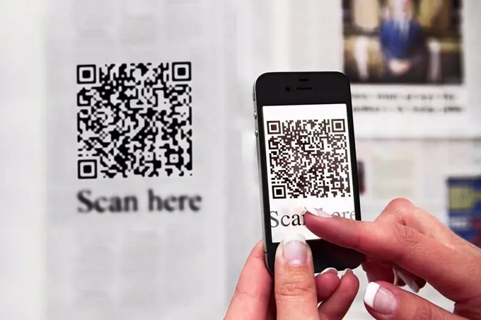 Woman scanning QR code with a smartphone