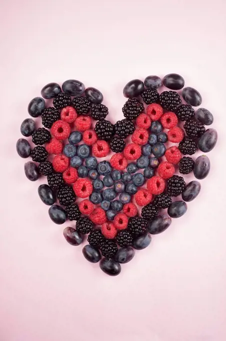 Fresh berries in heart shape, studio shot.