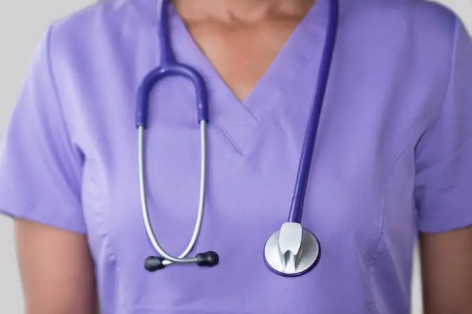 Female doctor in purple top with stethoscope