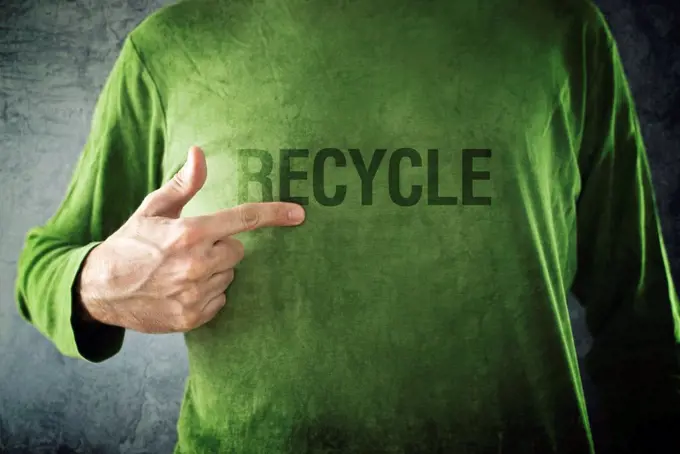 Man pointing to recycle printed on his shirt