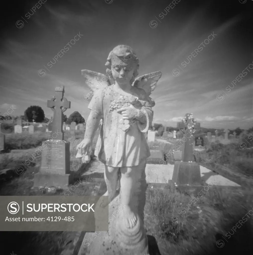 winged angel statue in cemetery