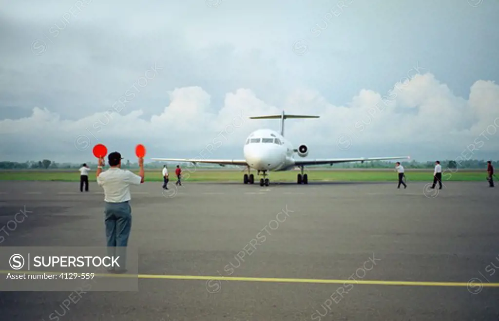 man directing plane after landing