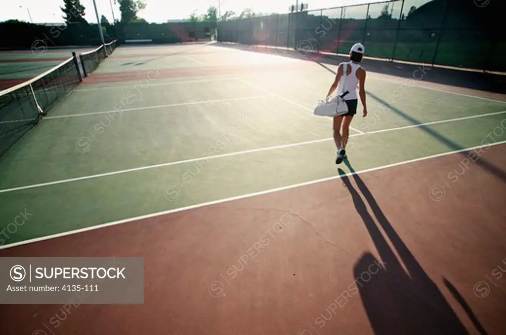 Woman walking on tennis court