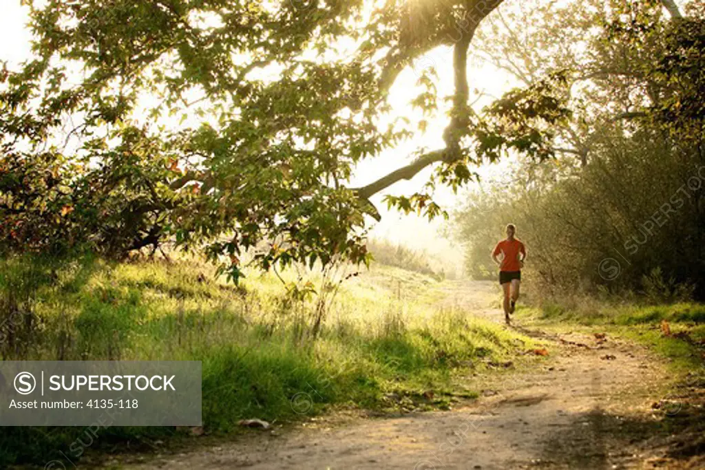 Man running at sunset in a park, San Clemente Canyon, San Diego County, California, USA