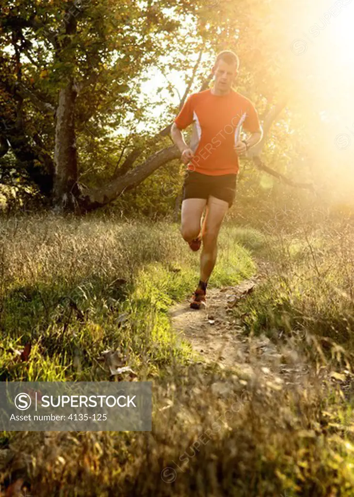 Man running at sunset in a park, San Clemente Canyon, San Diego County, California, USA