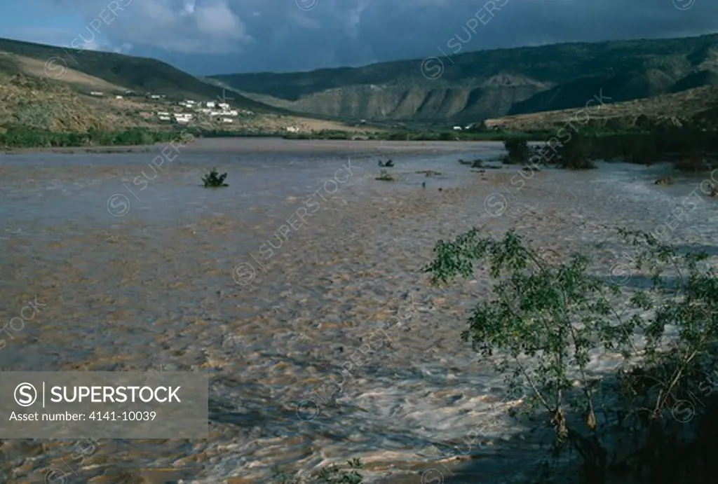 river in flood sedimented flood water in spate morocco, northern africa 