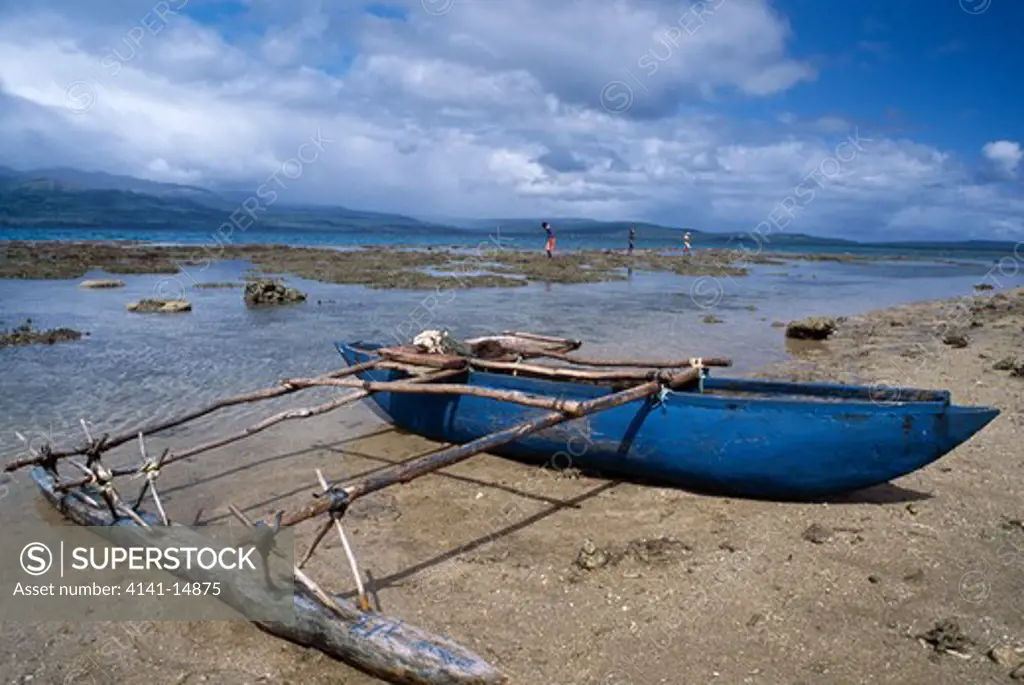 outrigger canoe pulled up on beach. nguna/pele marine protection area, nguna island, vanuatu.